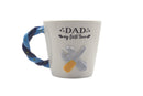 Mug with 'DAD my first love' text and a design of a penguin holding a fish, on a white background.